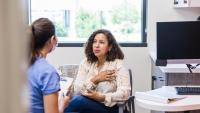 patient talking to doctor or nurse in an exam room